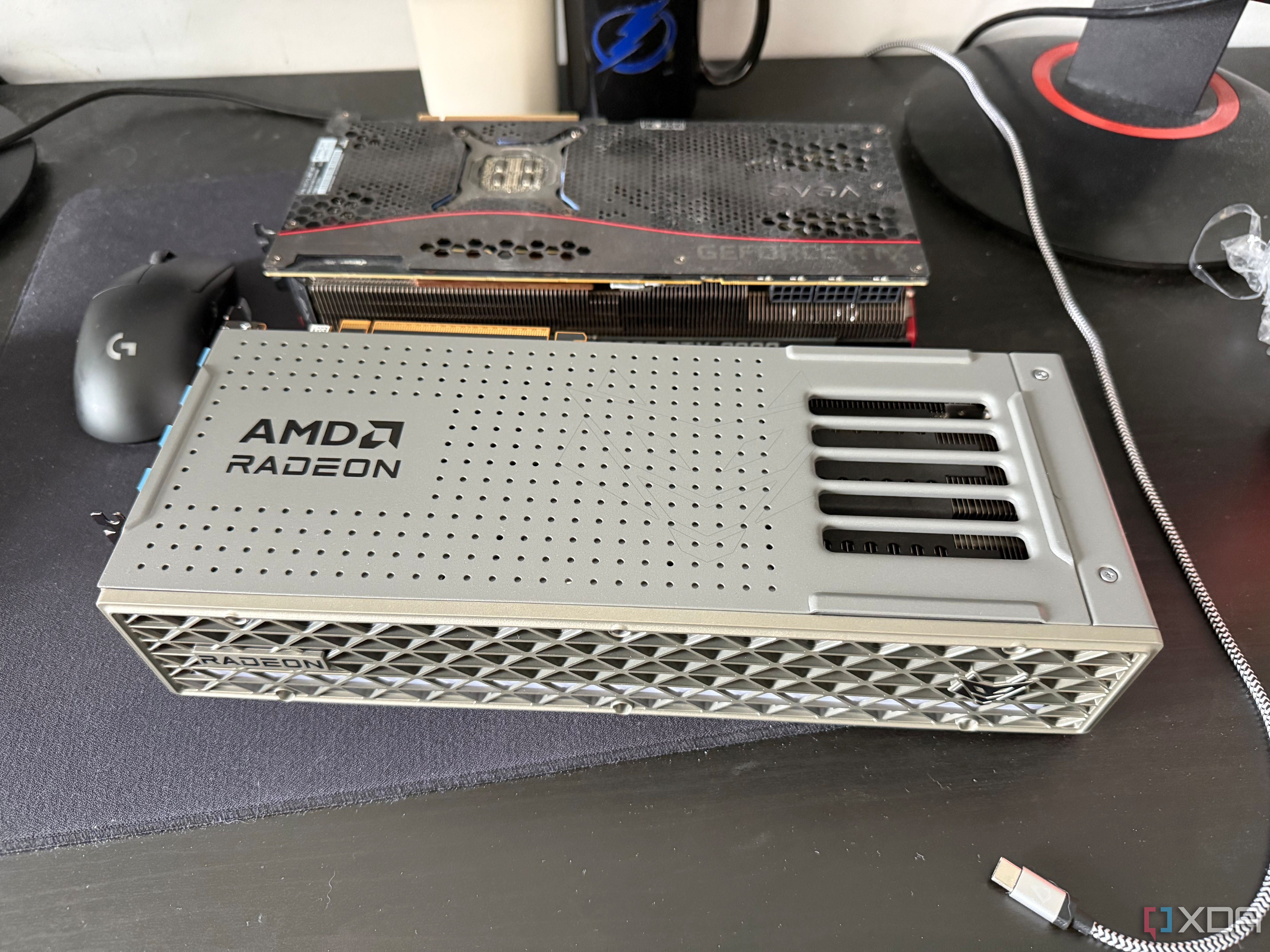 A photo of two GPUs on a table, one being an AMD Radeon RX 9070 XT, and the other an RTX 3080