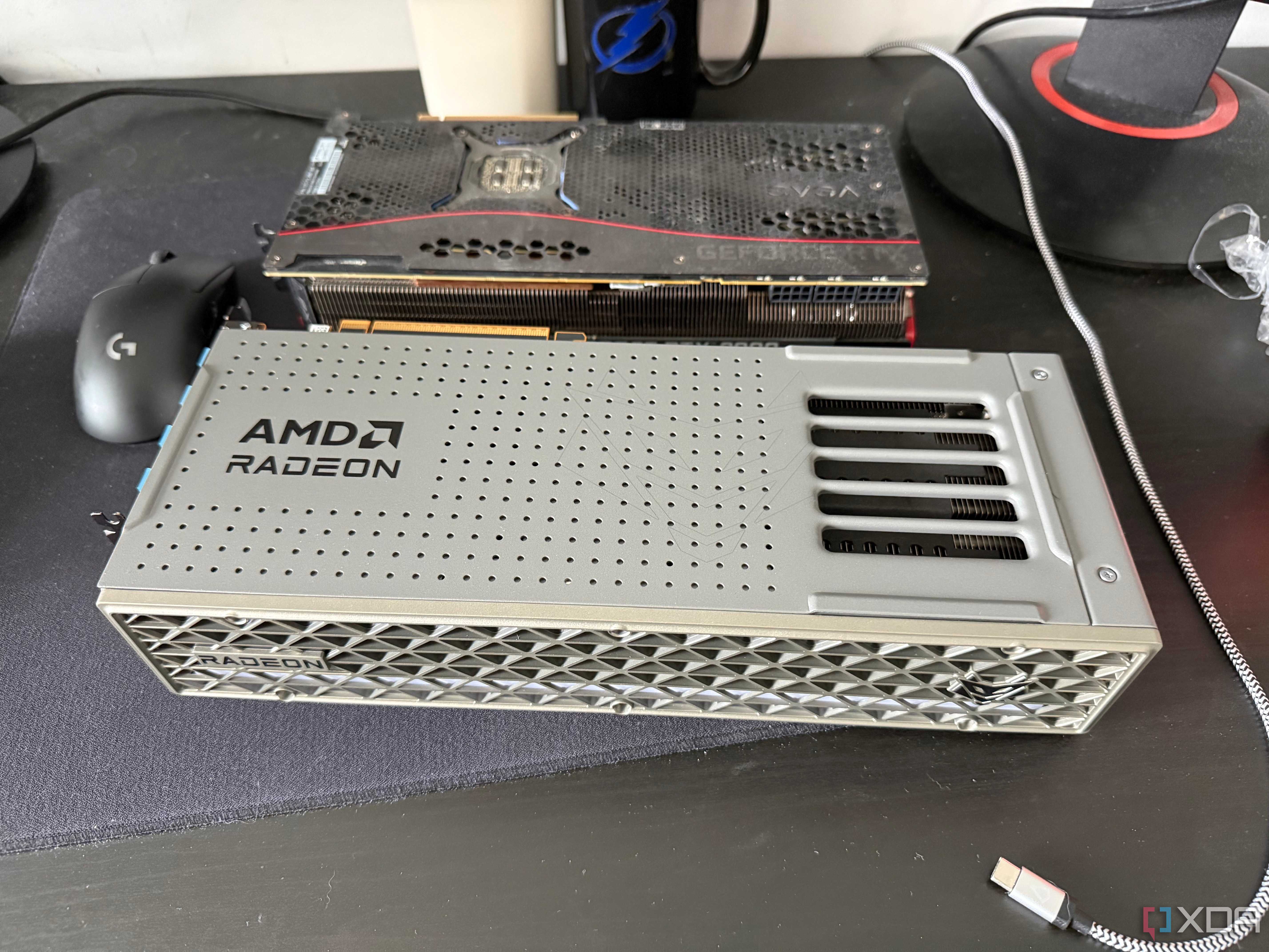 A photo of two GPUs on a table, one being an AMD Radeon RX 9070 XT, and the other an RTX 3080