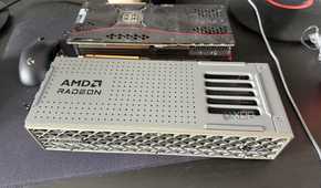 A photo of two GPUs on a table, one being an AMD Radeon RX 9070 XT, and the other an RTX 3080