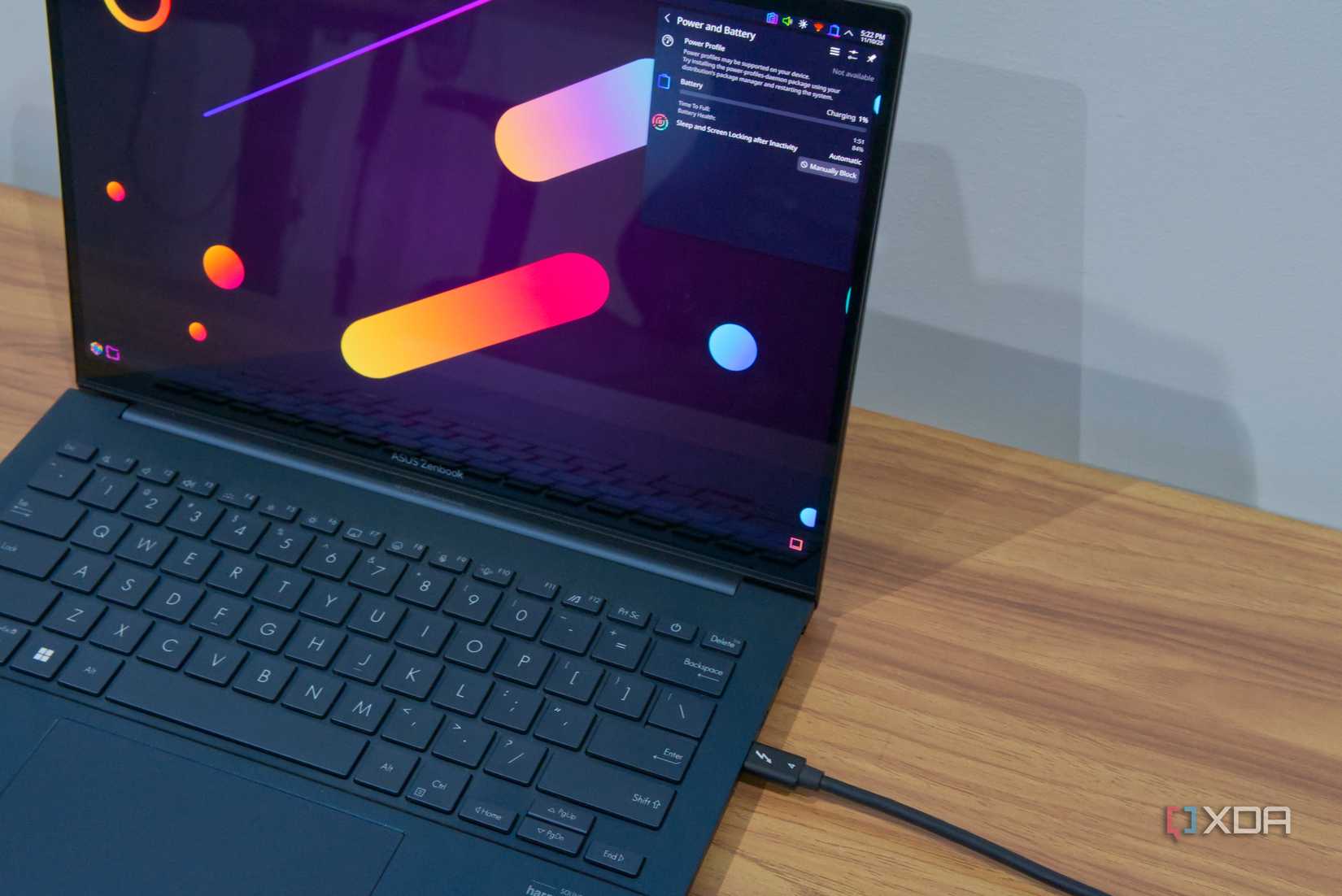 A laptop with a Thunderbolt cable connected and charging