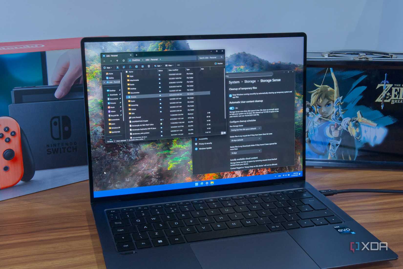 A Windows 11 laptop showing a OneDrive folder and Storage Sense settings
