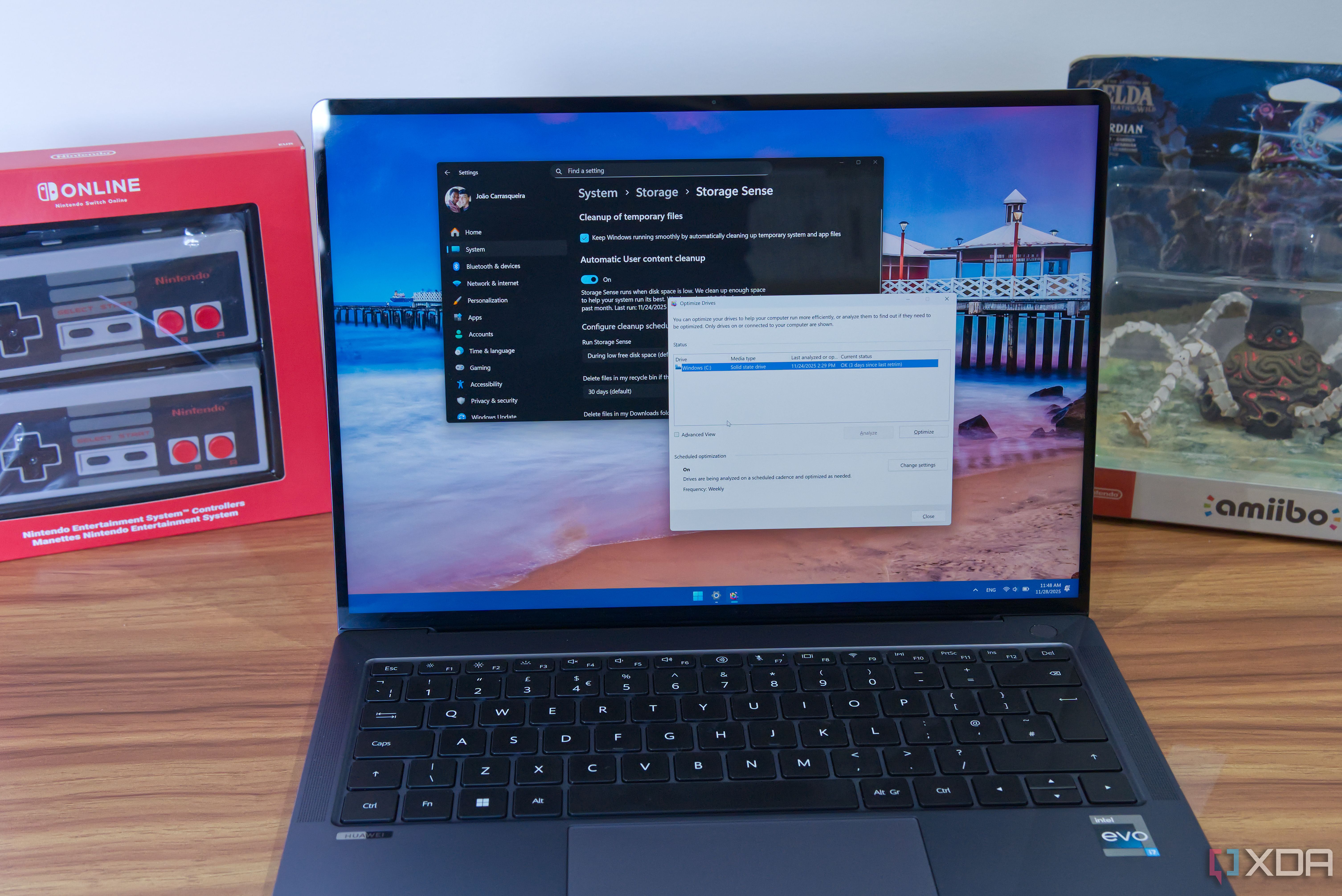 A Windows 11 laptop showing storage sense settings and the dialog for optimizing drives