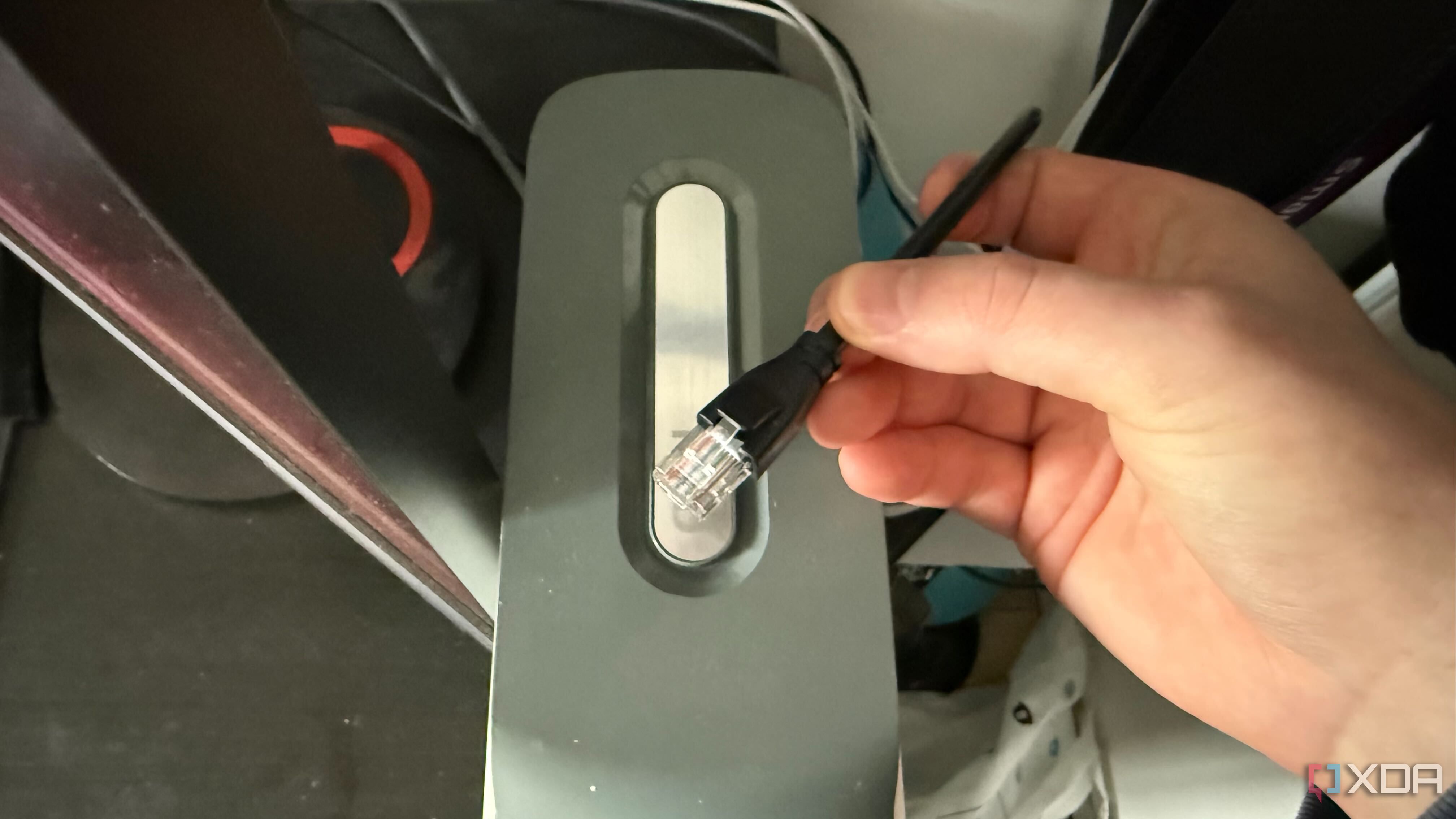 A photo of an ethernet cable on top of an Xbox 360 console