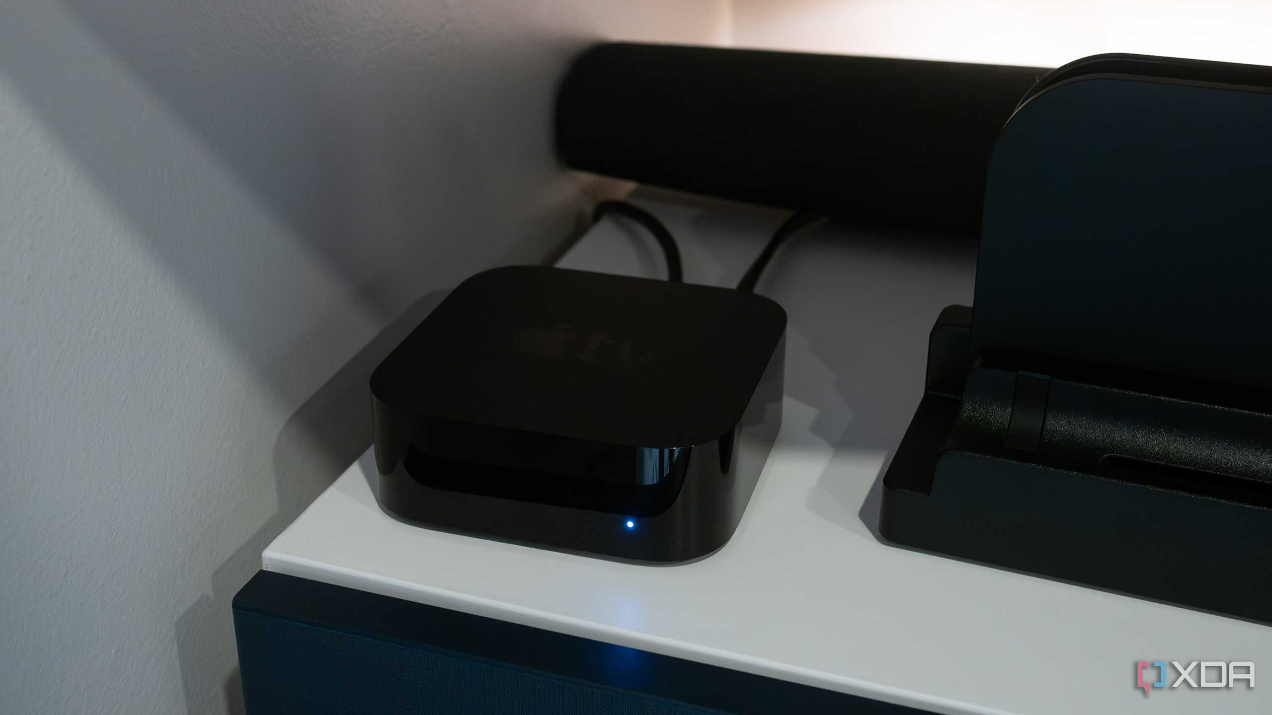 The Apple TV 4K sitting under a TV