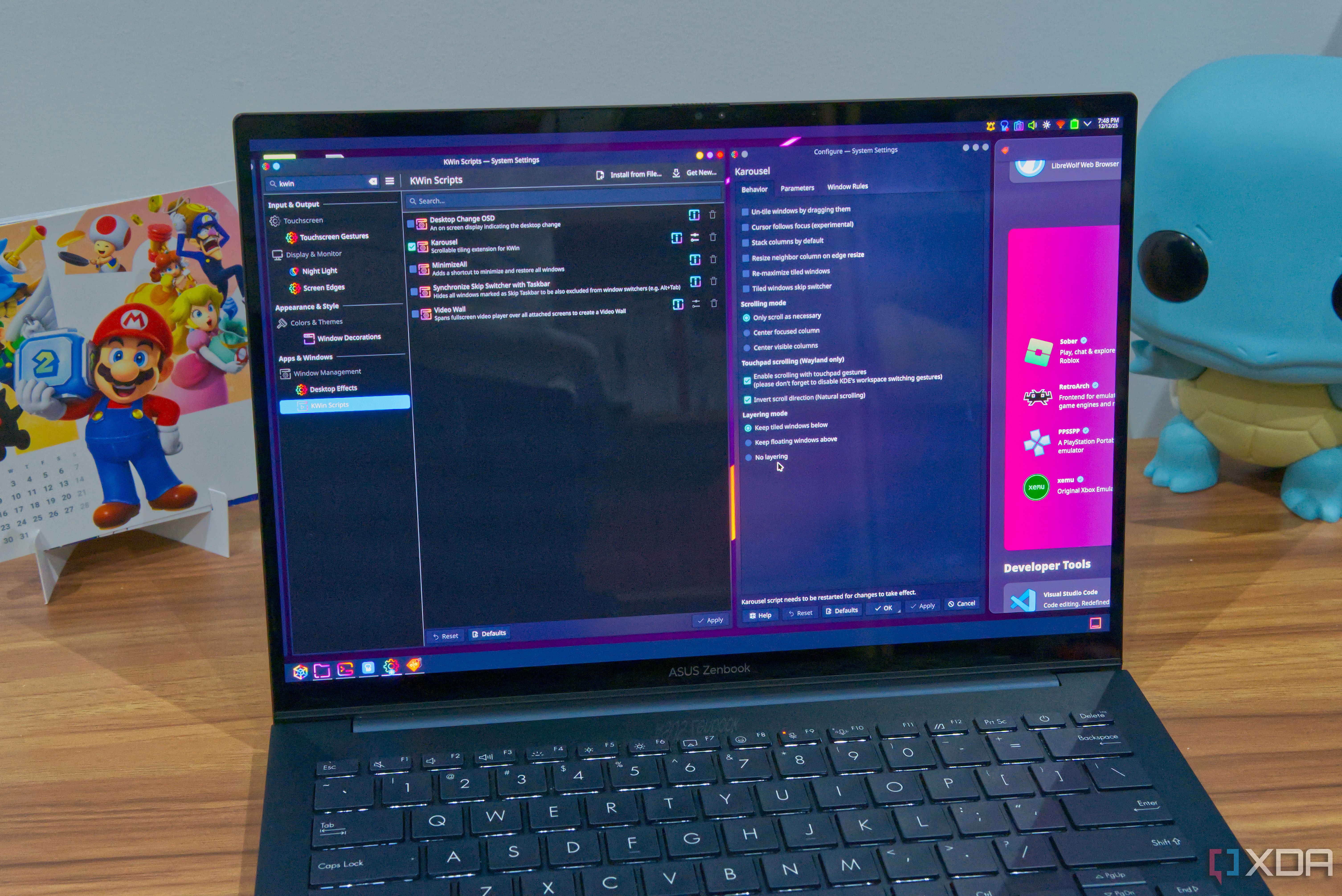 A laptop running KDE Plasma and using the Karousel script to created a scrollable, tiled window layout