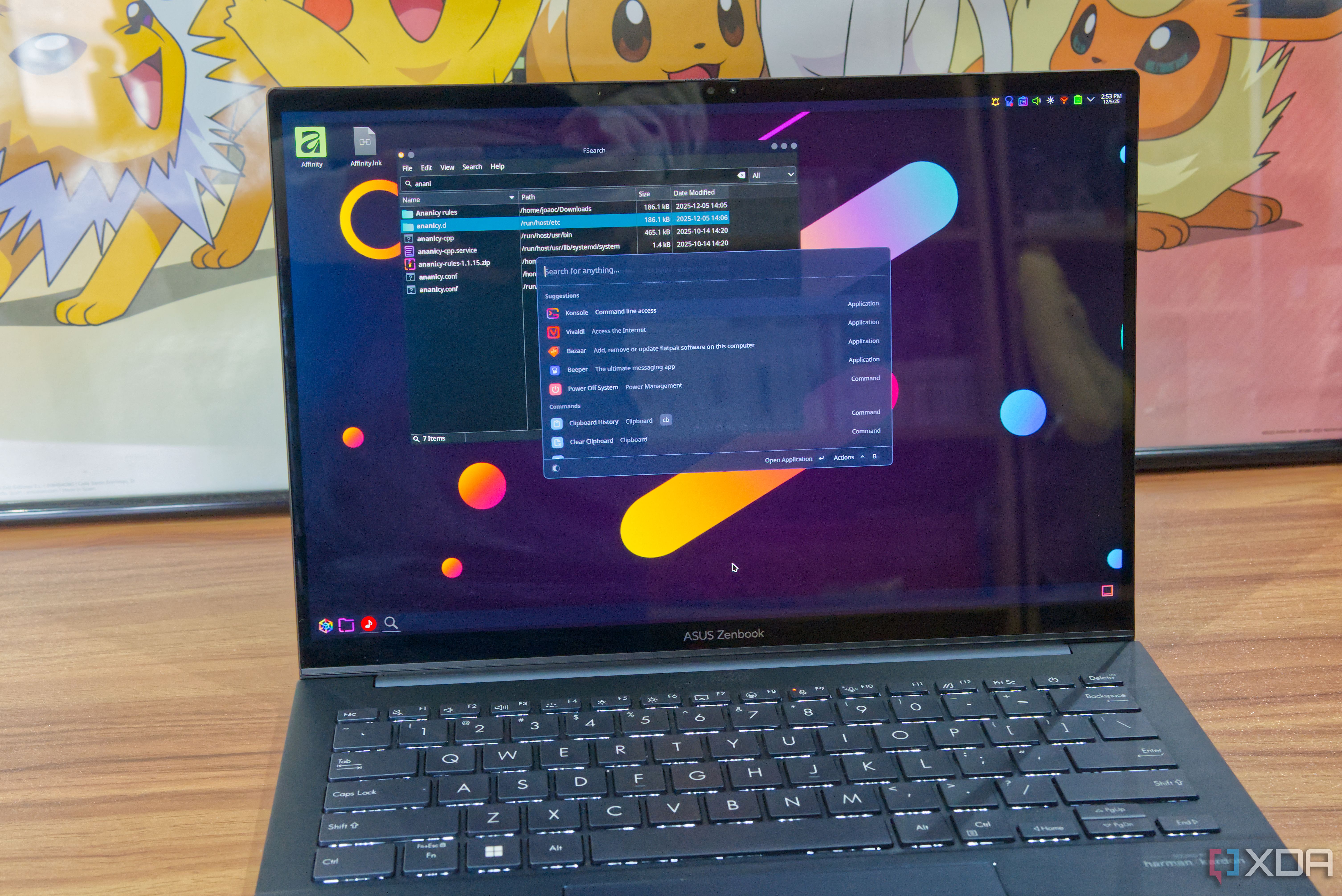 A Linux laptop showing tools including Vicinae and FSearch