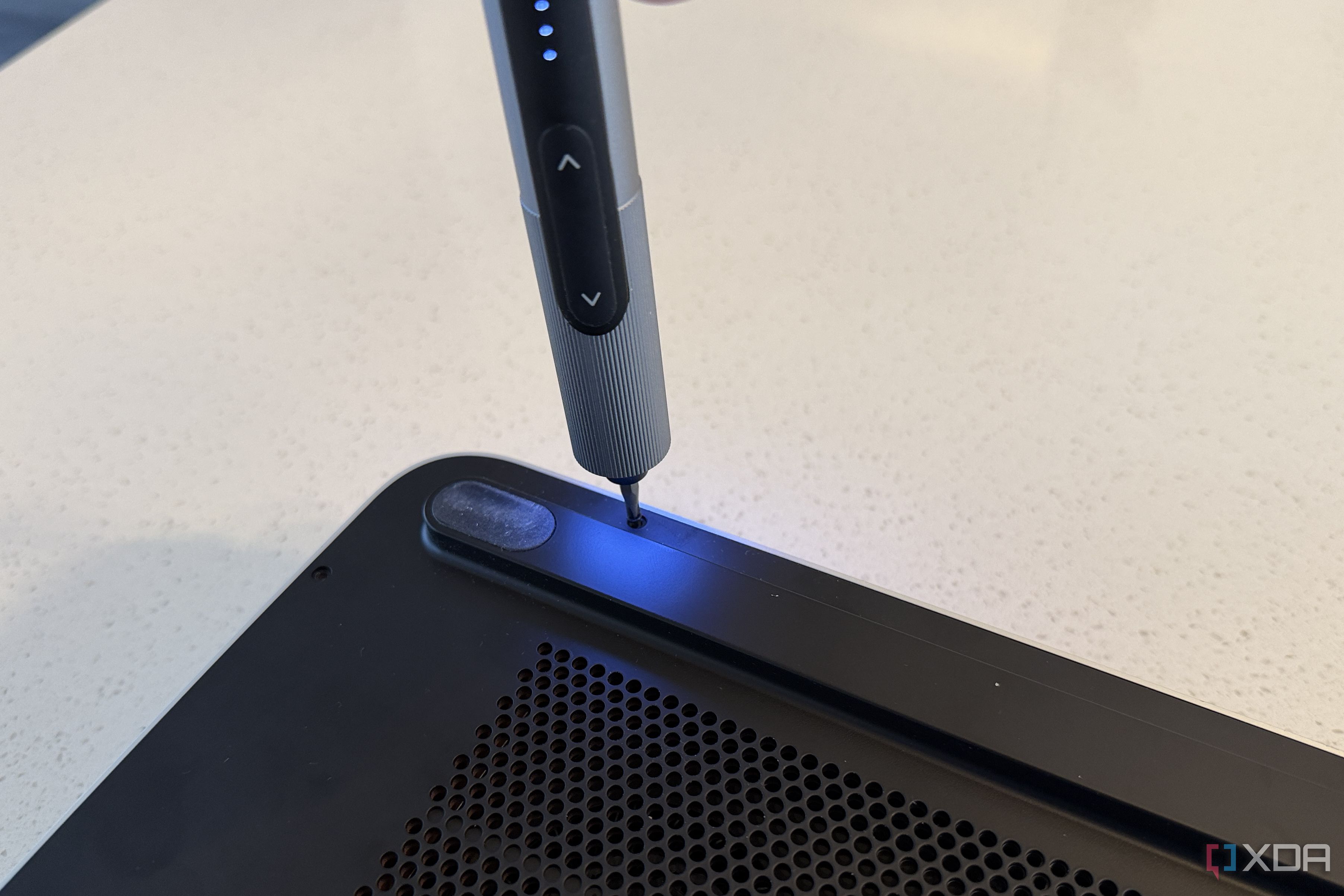 olares one mini PC for AI being opened by an electric screwdriver