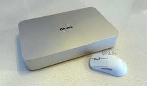 olares one mini PC for AI on a countertop next to a white mouse