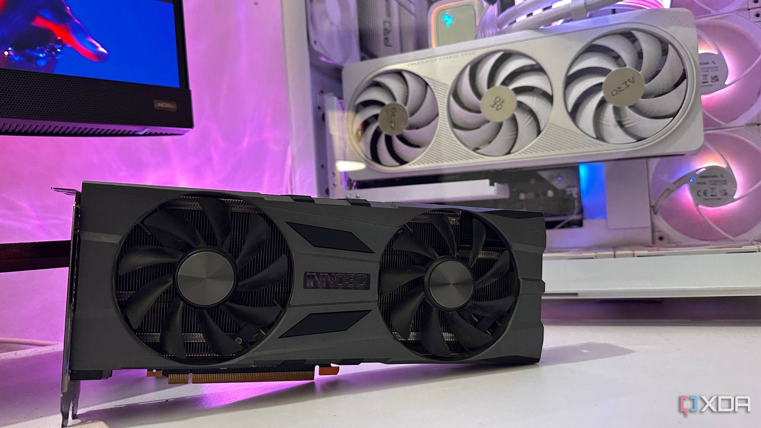 An RTX 2070 Super on a desk next to a gaming PC.