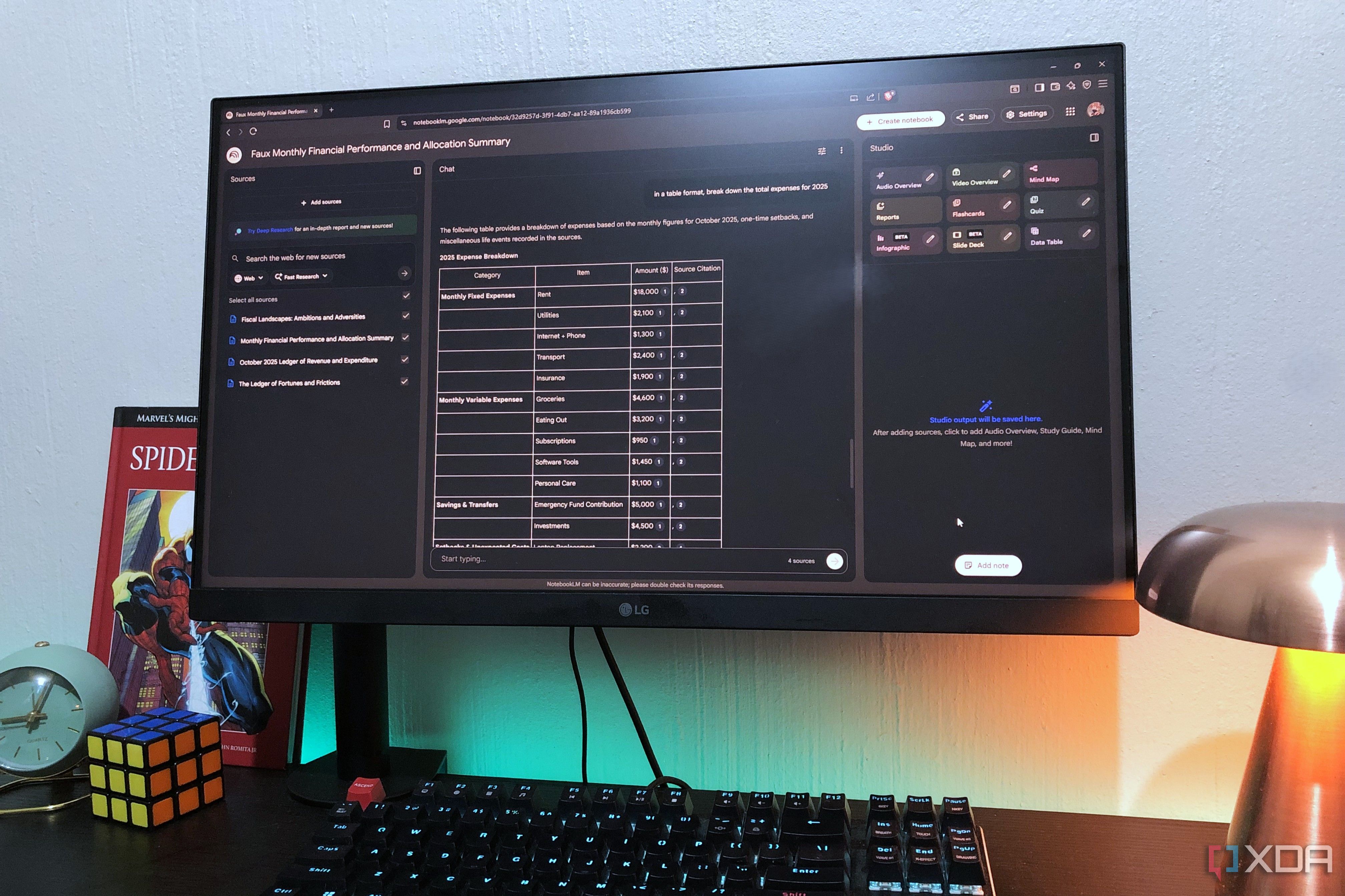 NotebookLM finances on desktop pc, lamp and book in view