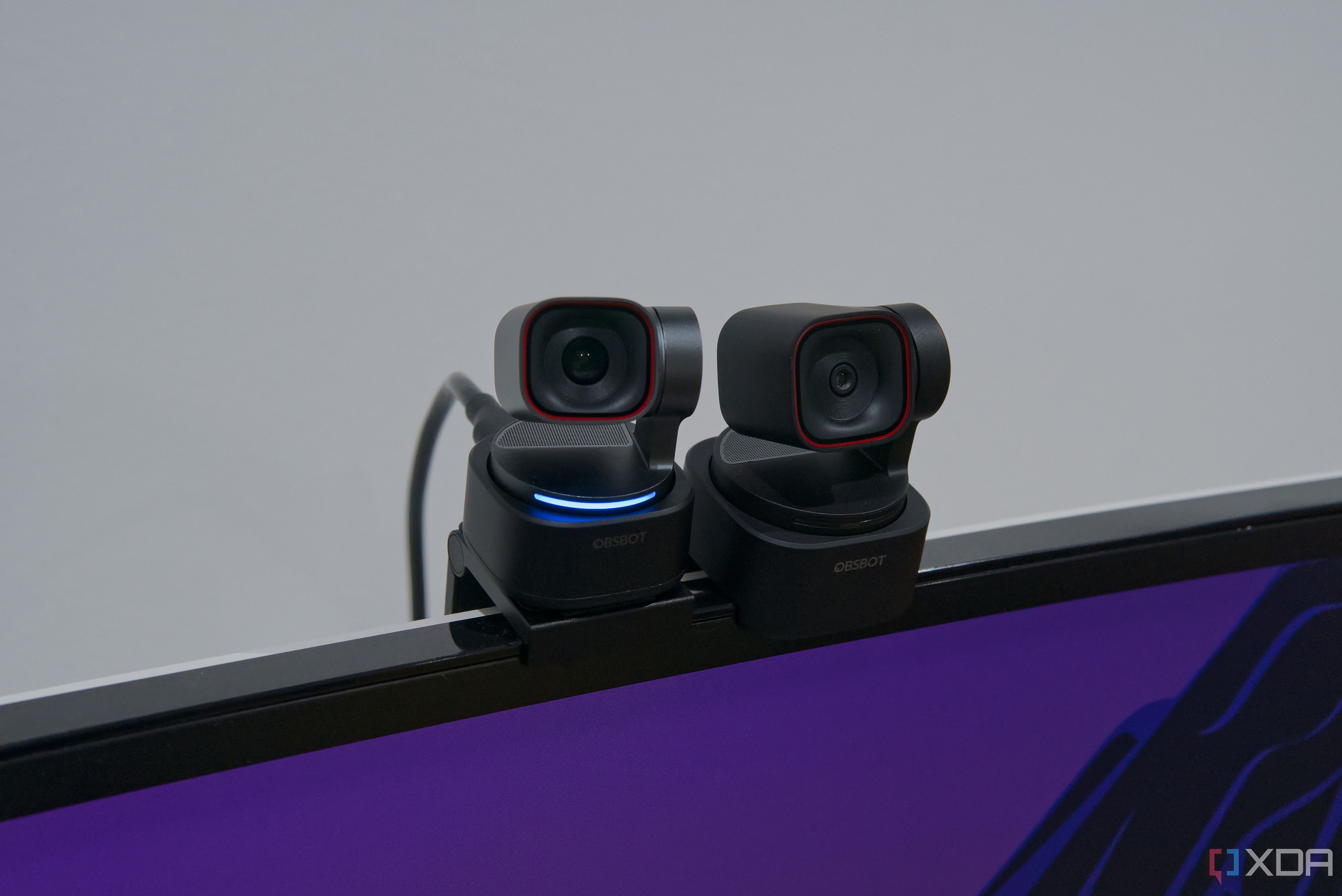 Monitor-mounted Obsbot Tiny 3 and Obsbot Tiny 3 Lite. Obsbot Tiny 3 has turned on the status light