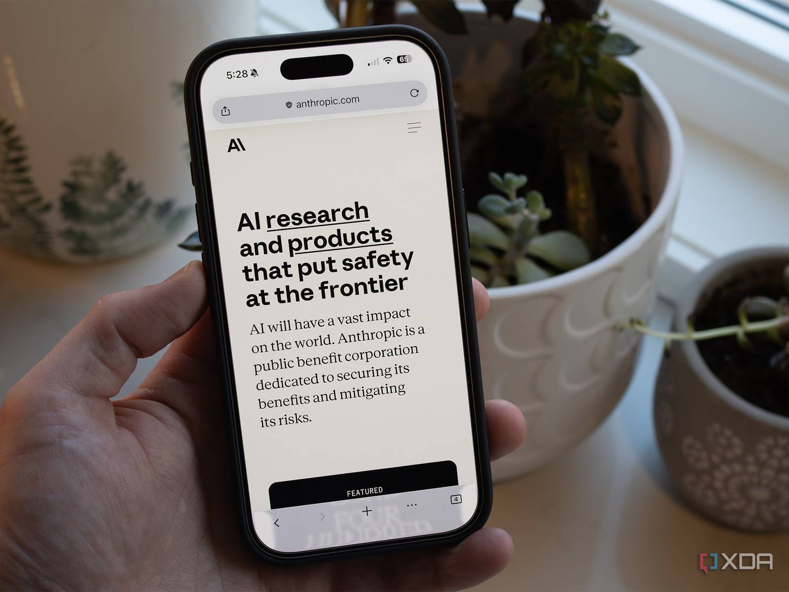 Anthropic AI website on phone screen representing the company's safety focus in military ban controversy