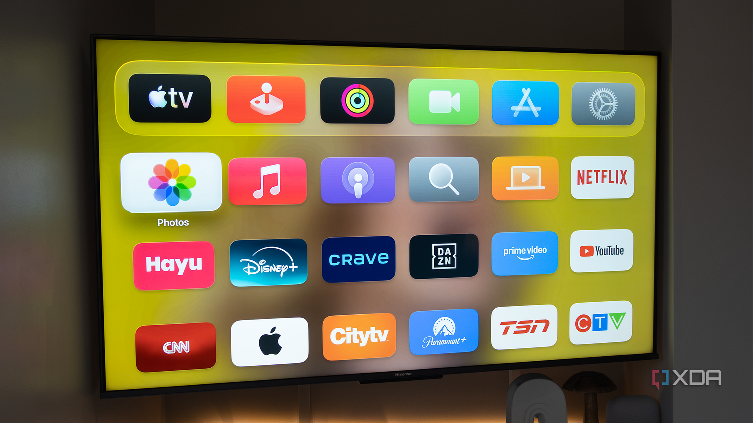 The Apple TV's home screen in a dark room
