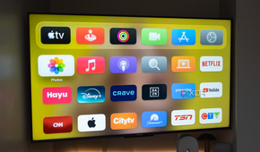 The Apple TV's home screen in a dark room