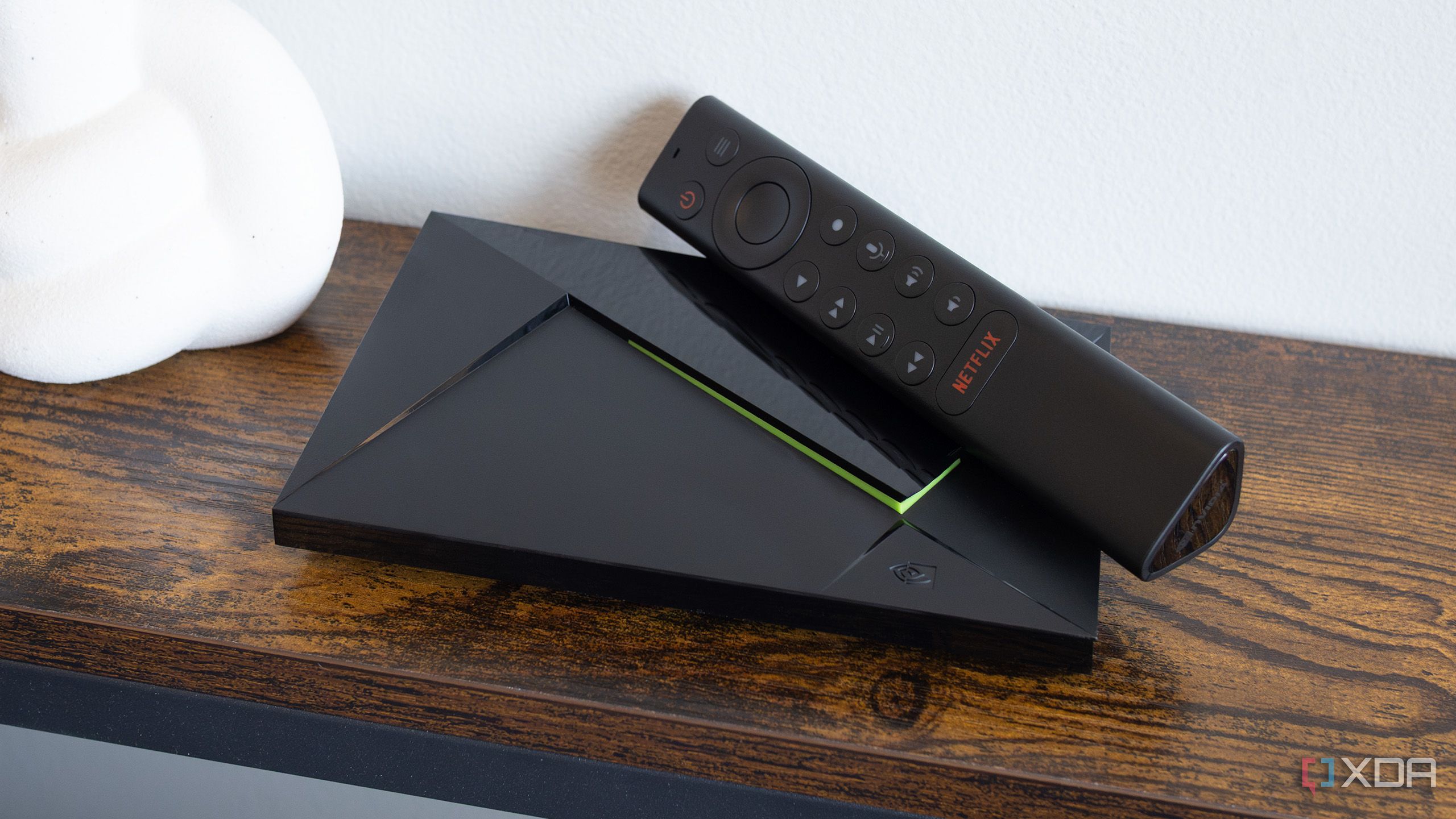 The Nvidia Shield TV and its remote sitting on a table
