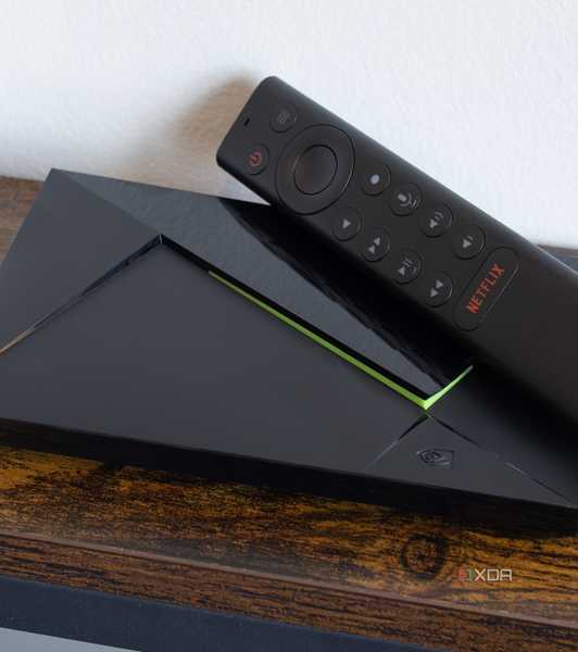 The Nvidia Shield TV and its remote sitting on a table