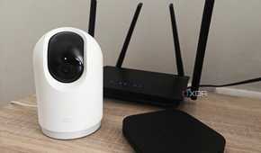 smart home devices on a table including a camera and tv box