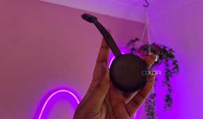 Chromecast in front of pink wall and plants