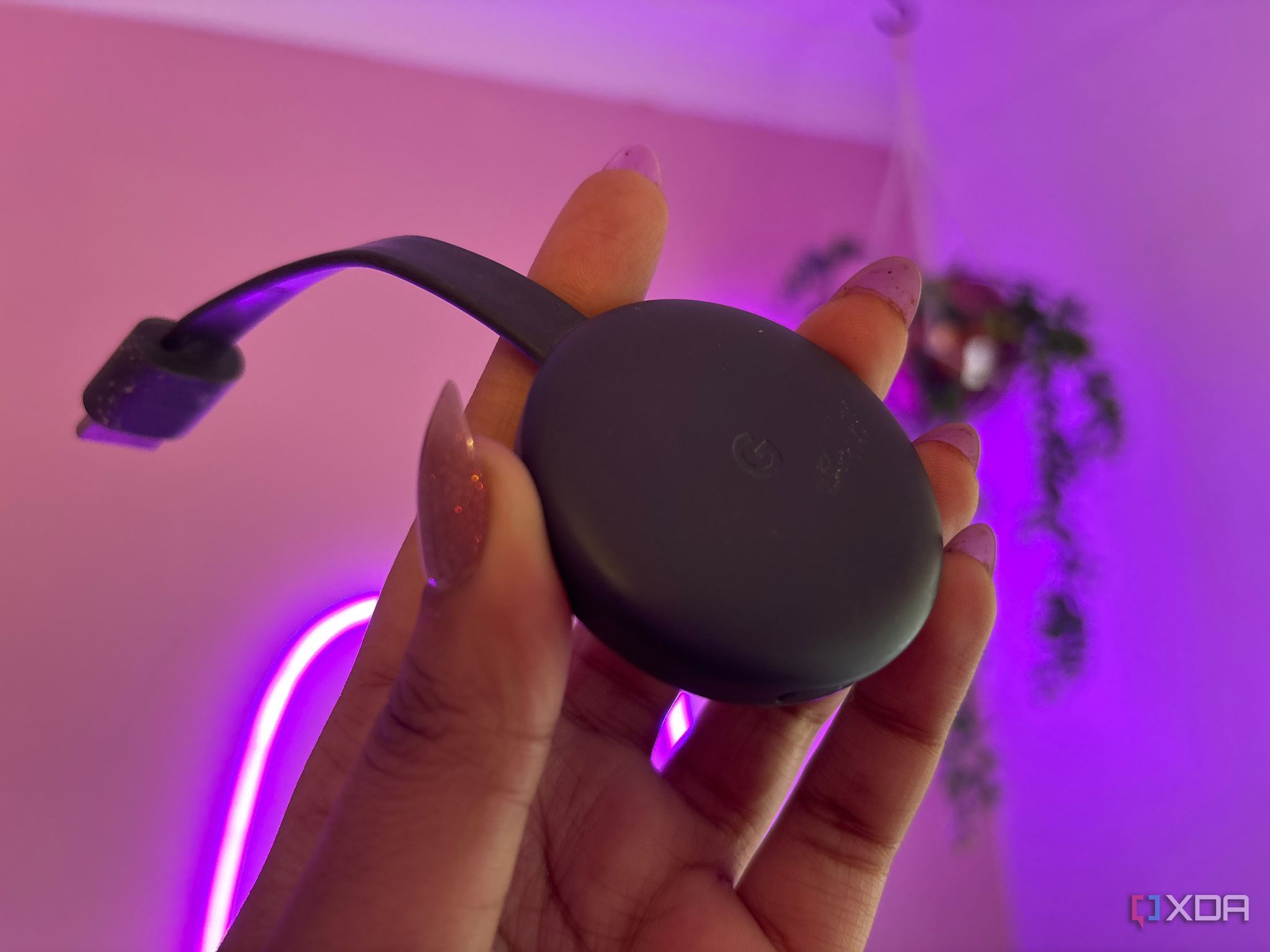 Chromecast in front of pink wall