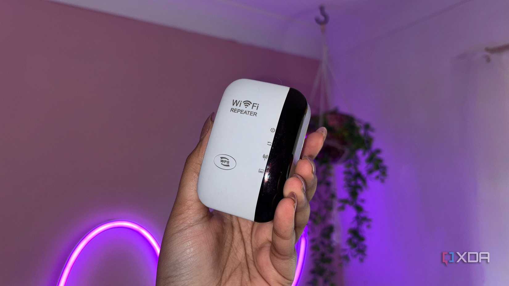 Wifi Extender next to pink wall