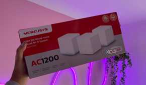 Mercusys mesh wifi system packaging next to pink wall