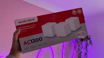 Mercusys mesh wifi system packaging next to pink wall