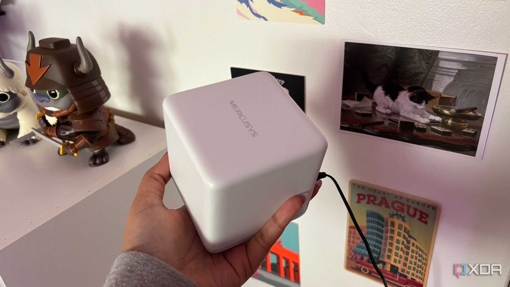 Mercusys mesh wifi system node top shot in front of postcards