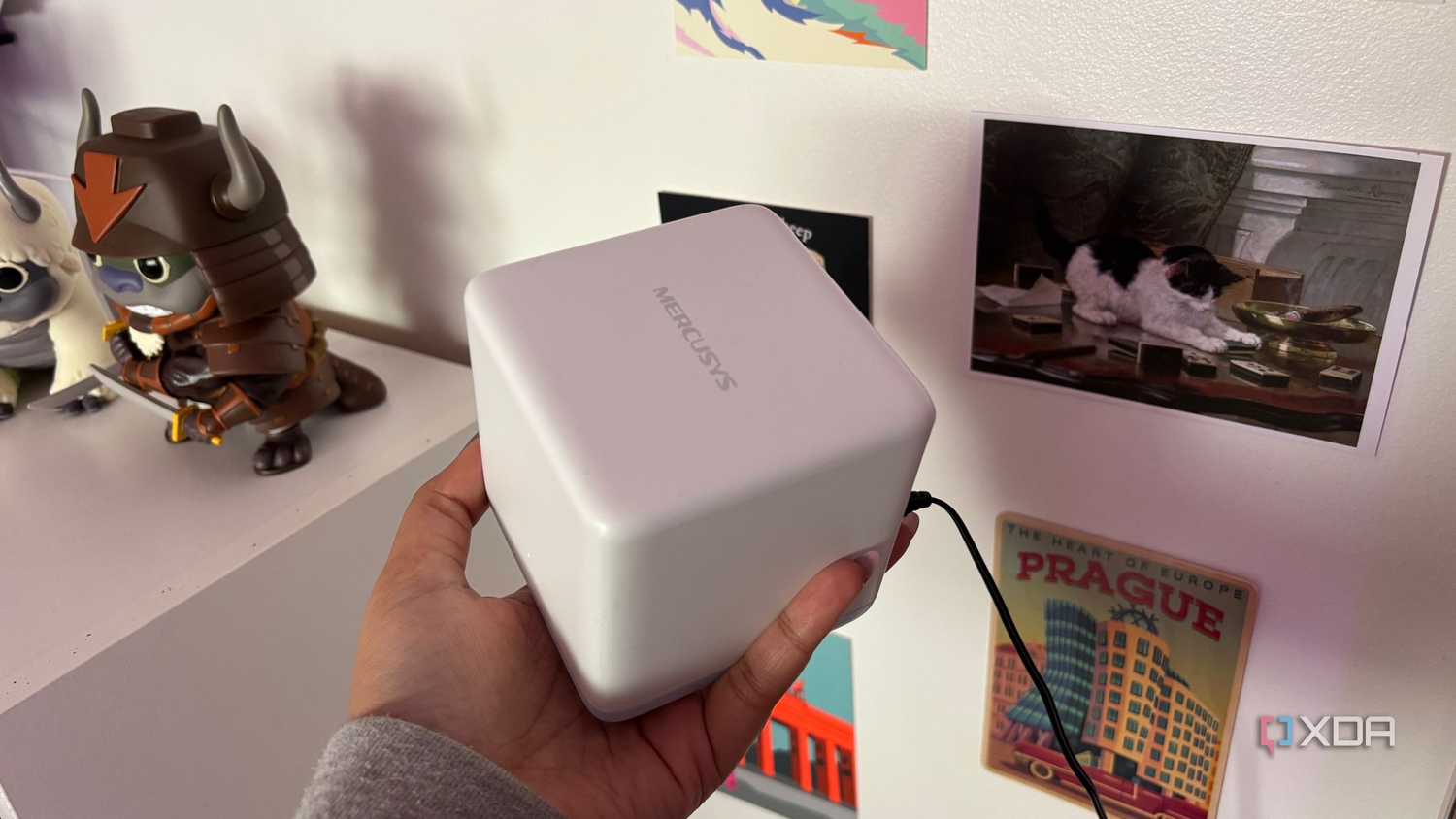 Mercusys mesh wifi system node top shot in front of postcards