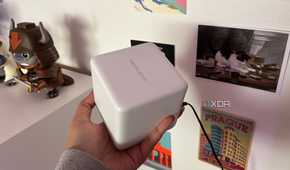 Mercusys mesh wifi system node top shot in front of postcards