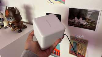Mercusys mesh wifi system node top shot in front of postcards