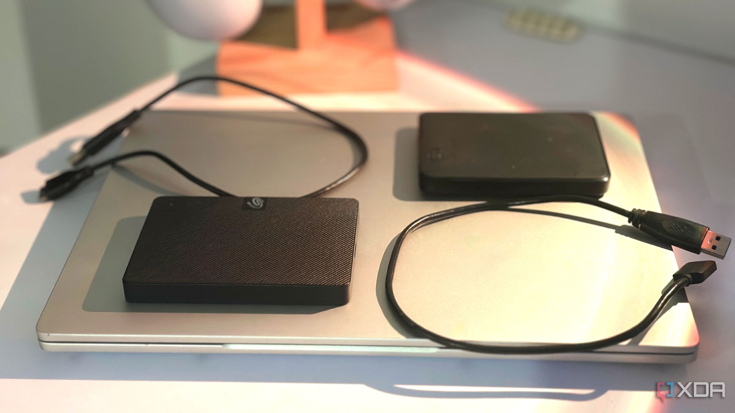 Two external hard drives on a laptop.