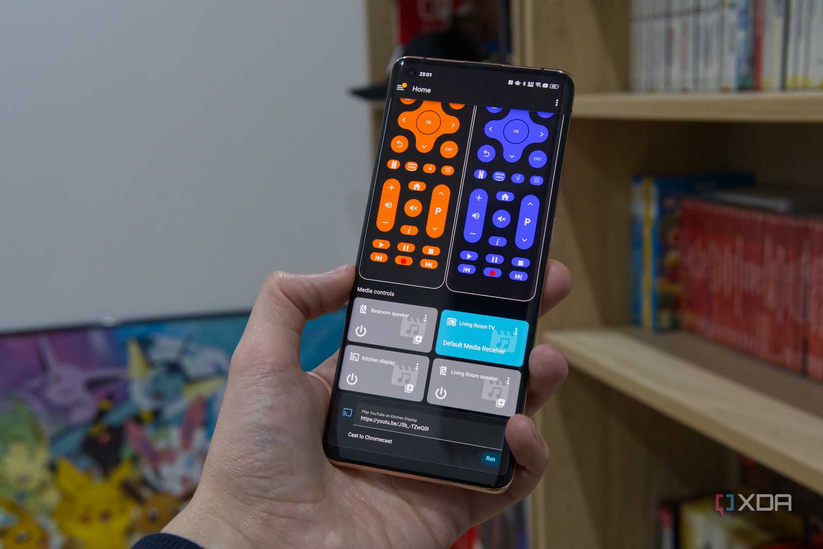 A phone showing TV remote controls and media controls in Home Assistant