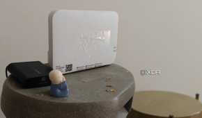 A white Wi-Fi 6 router on a grey surface
