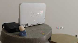 A white Wi-Fi 6 router on a grey surface