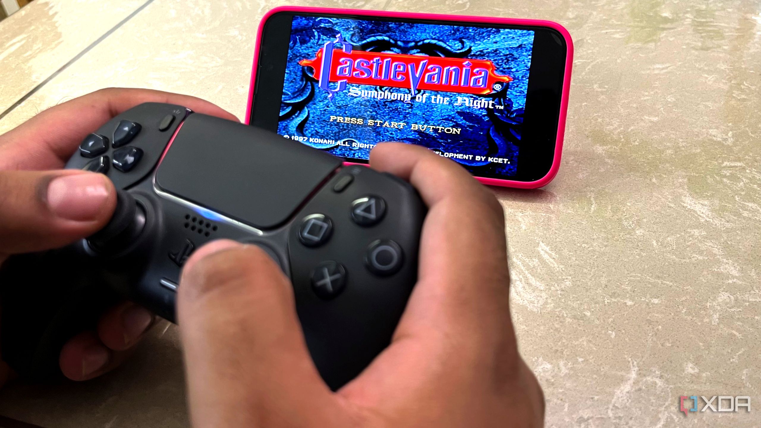 Playing Castlevania on an iPhone with RetroArch using a black DualSense controller.