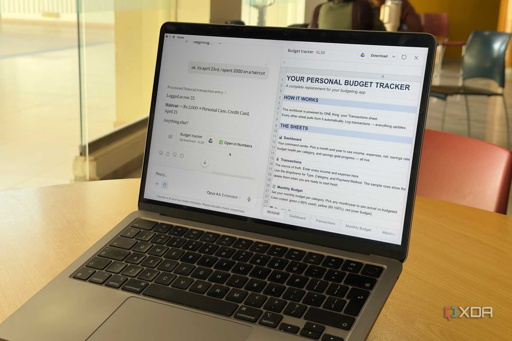 laptop displaying personal budget tracker webpage on wooden desk in office setting