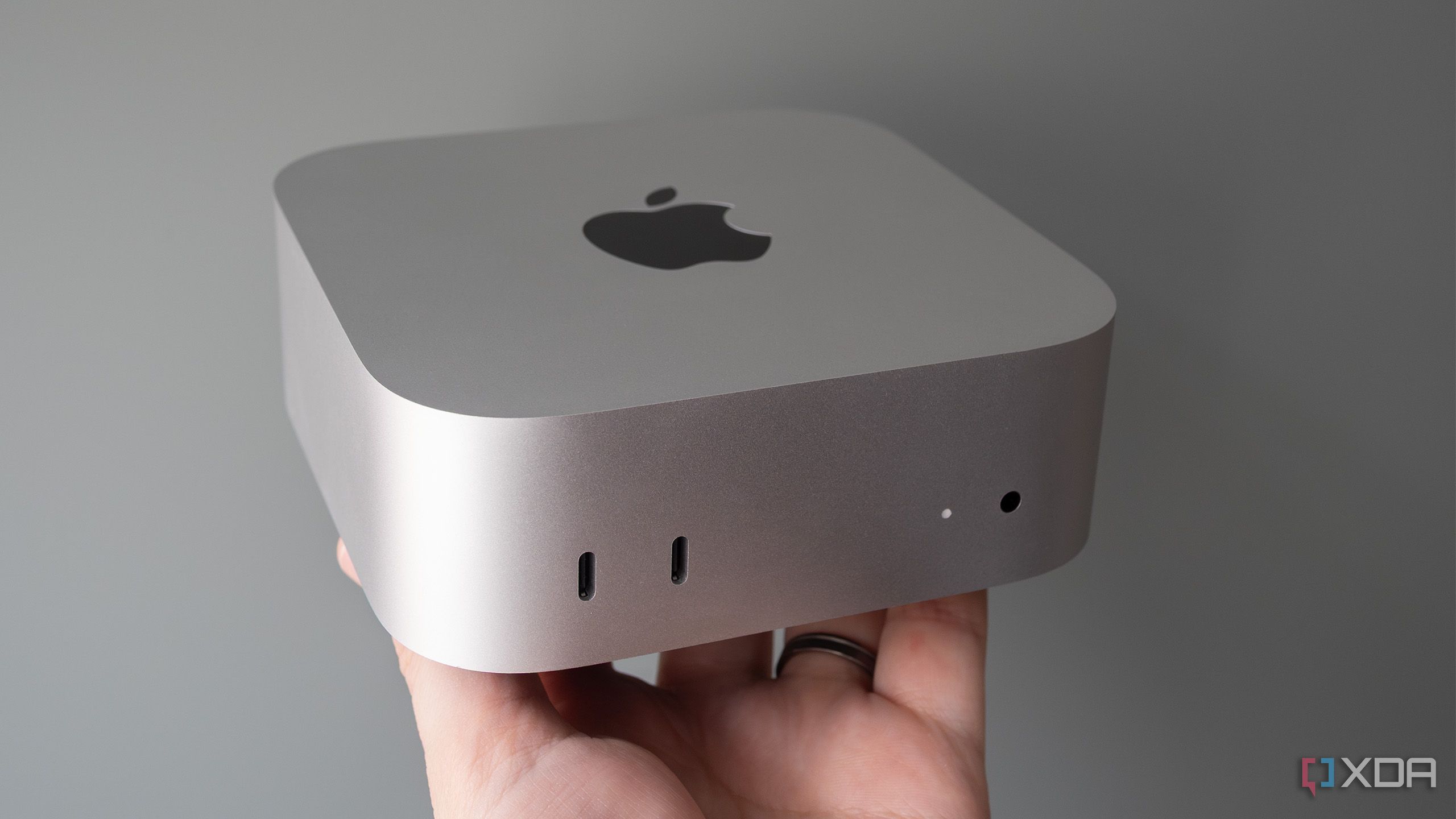 Holding the M4 Mac mini 
