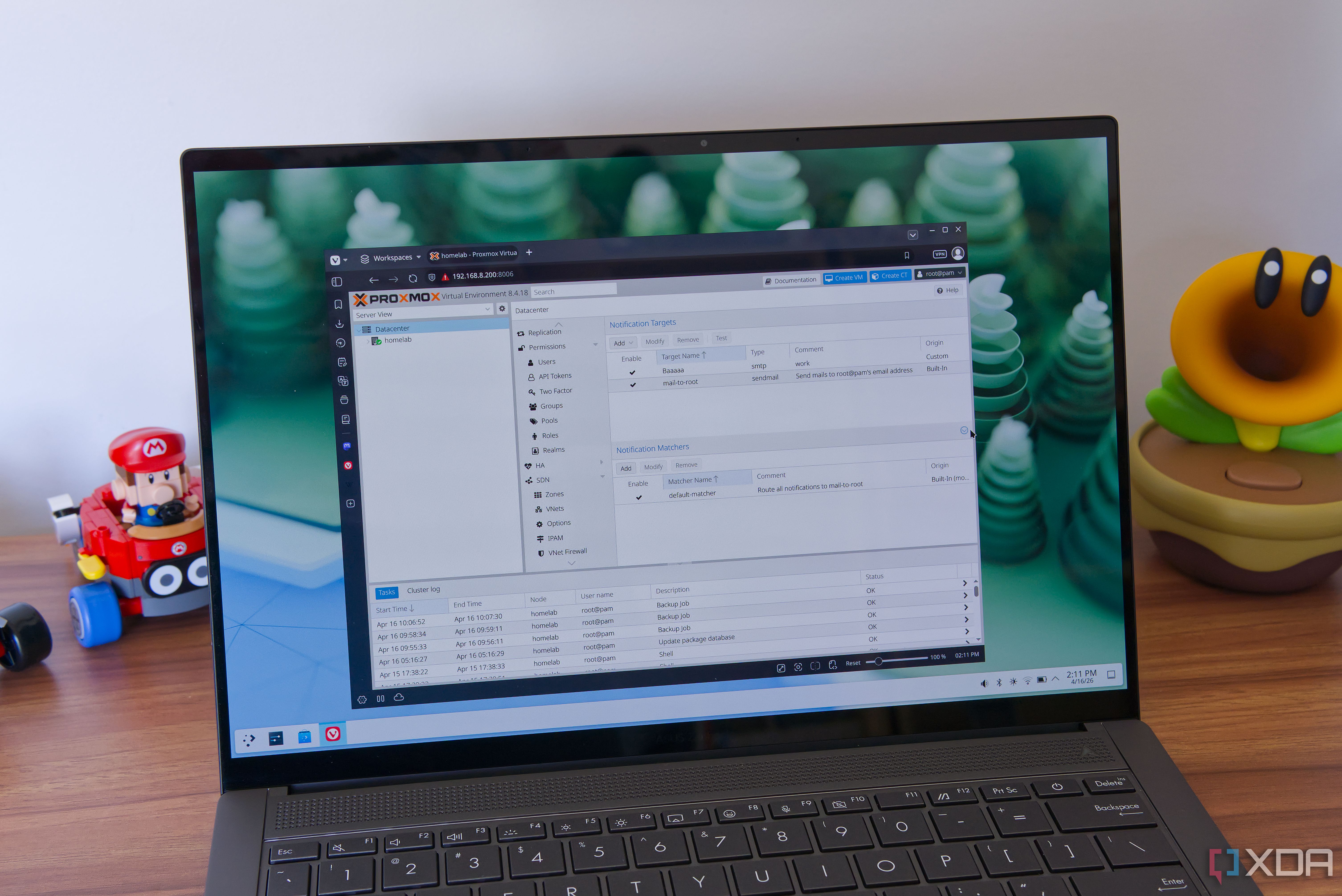 A laptop showing a Proxmox dashboard inside a browser, showing the notification settings
