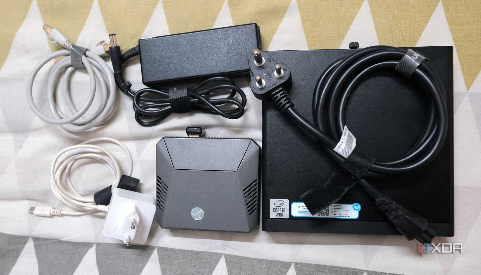 A Raspberry Pi in Argon40 case with HP mini PC with power cables