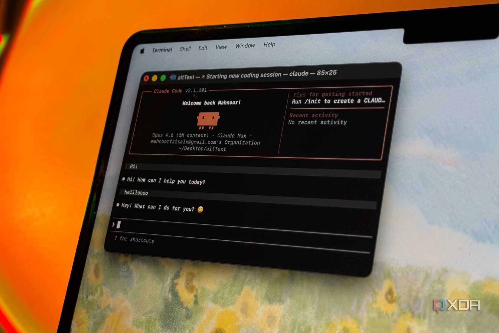 terminal window with claude ai assistant chat interface on mac laptop screen