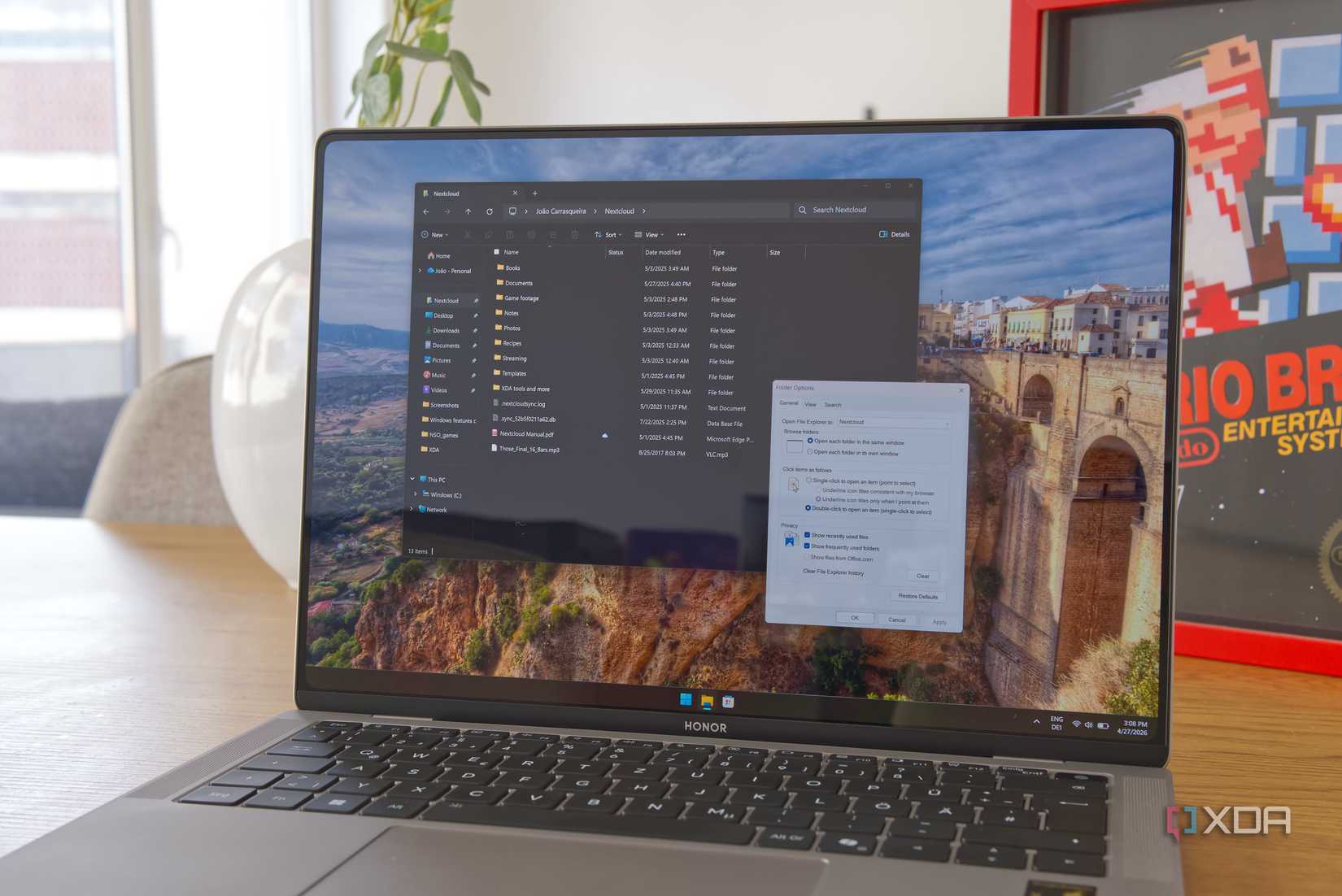 A Windows 11 laptop running File Explorer and displaying the options window