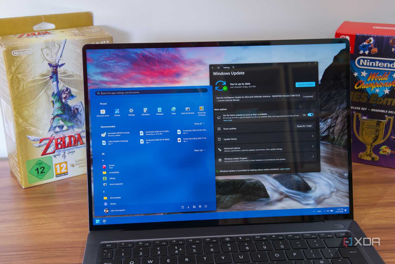 Laptop showing Windows 11 Start menu and Windows Update settings