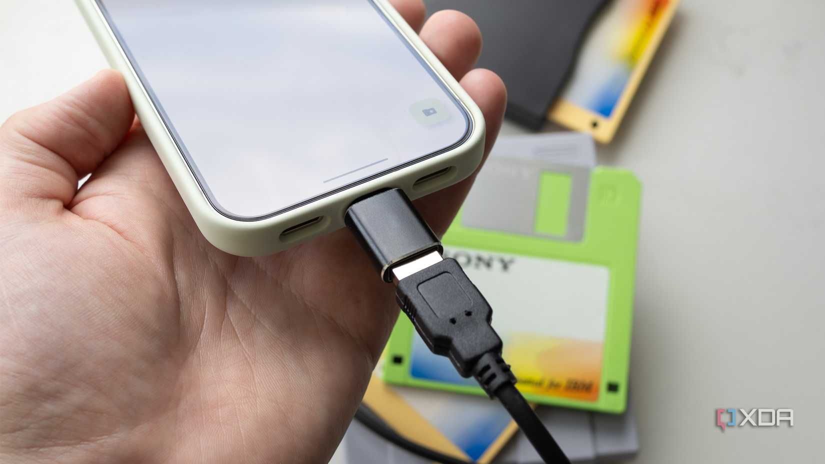 A 3.5-inch floppy disk drive hooked up to a Pixel 10 Pro 