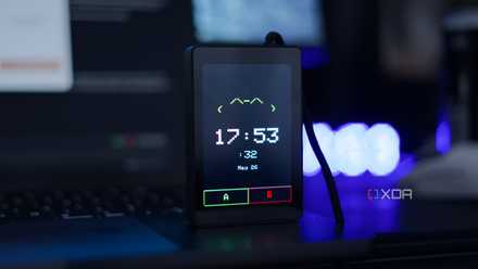 Claude Desk Buddy ported to the WT32-SC01 Plus, showing the current time and date with A and B buttons