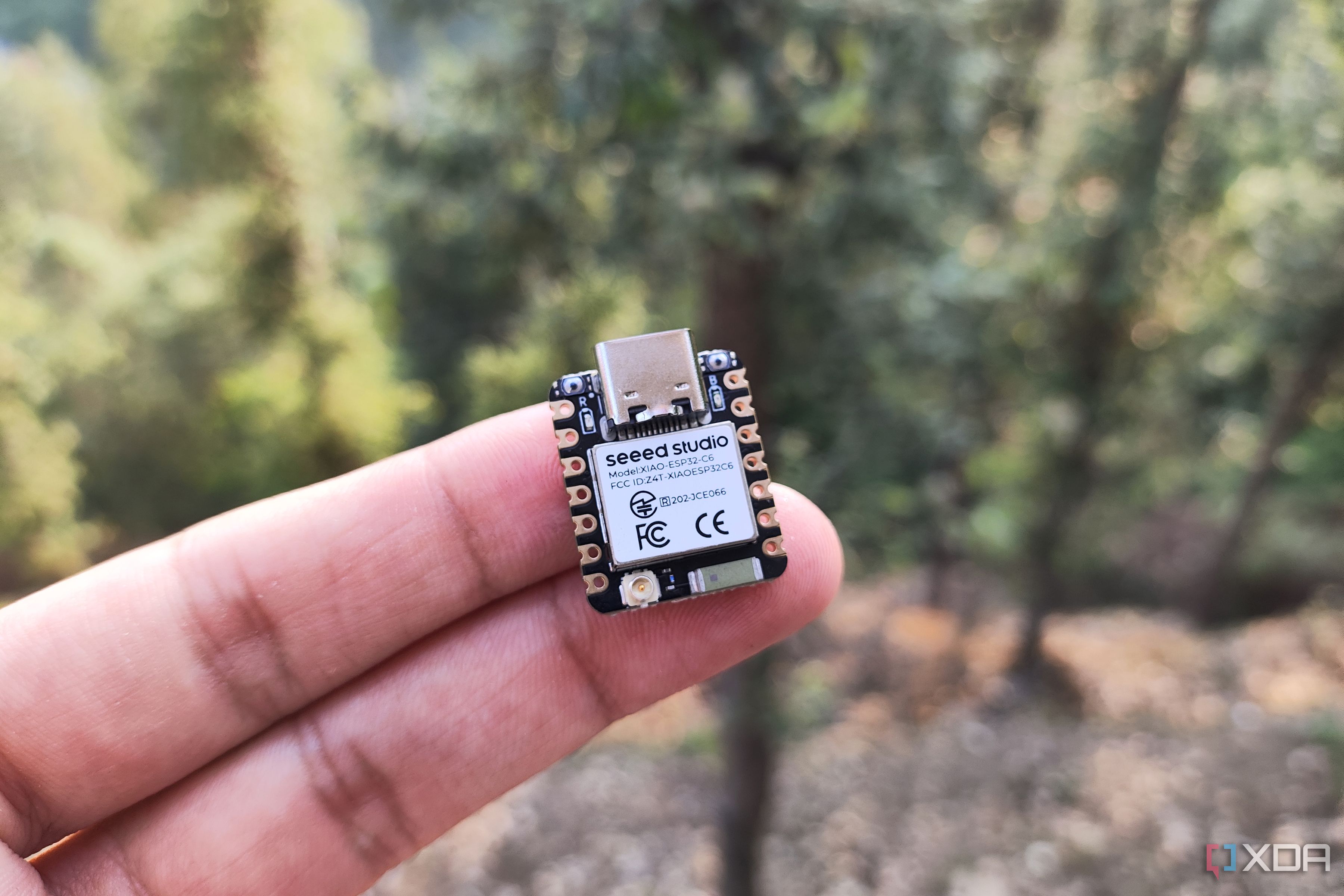 A person holding an ESP32-C6 board