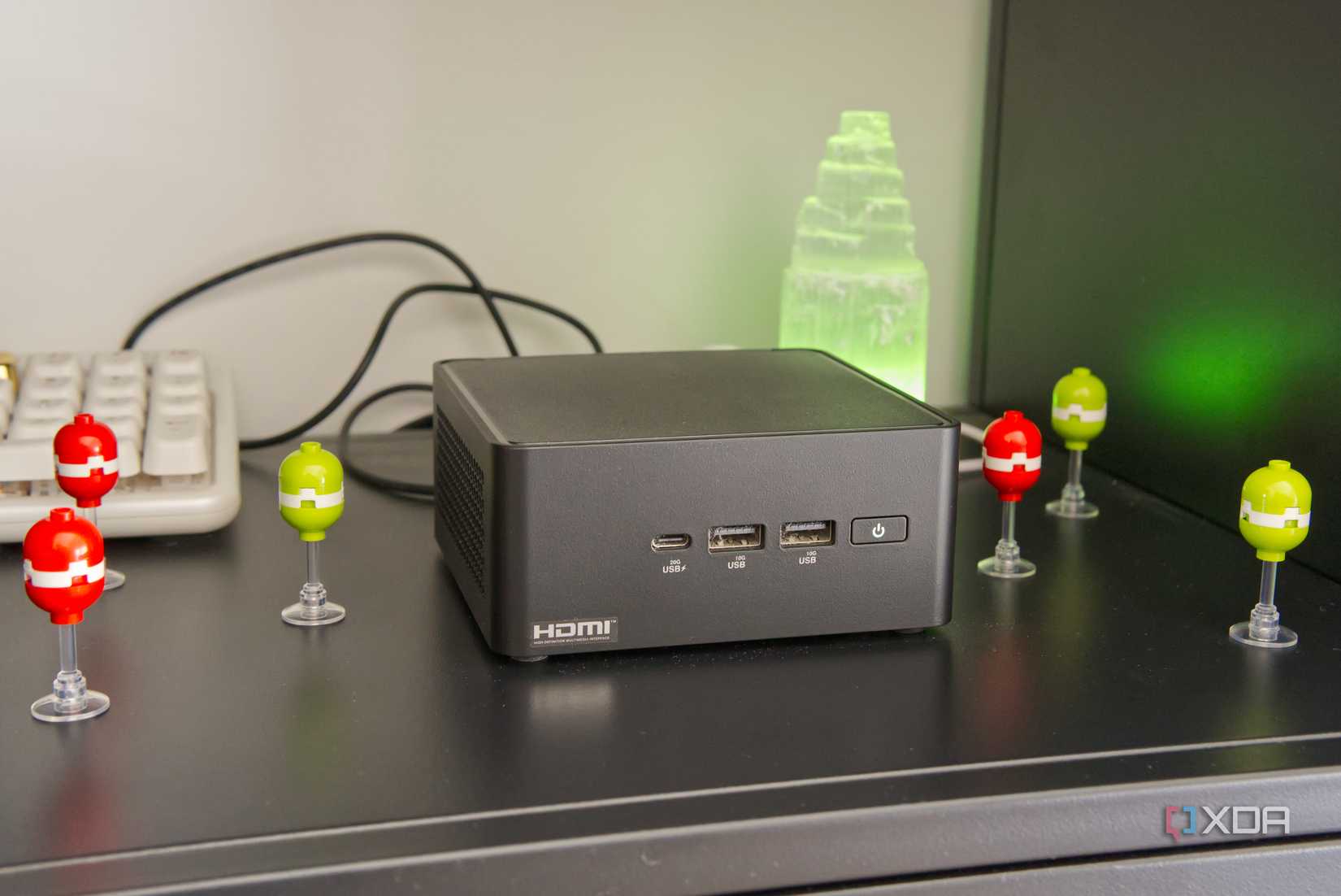 A mini computer on a black shelf