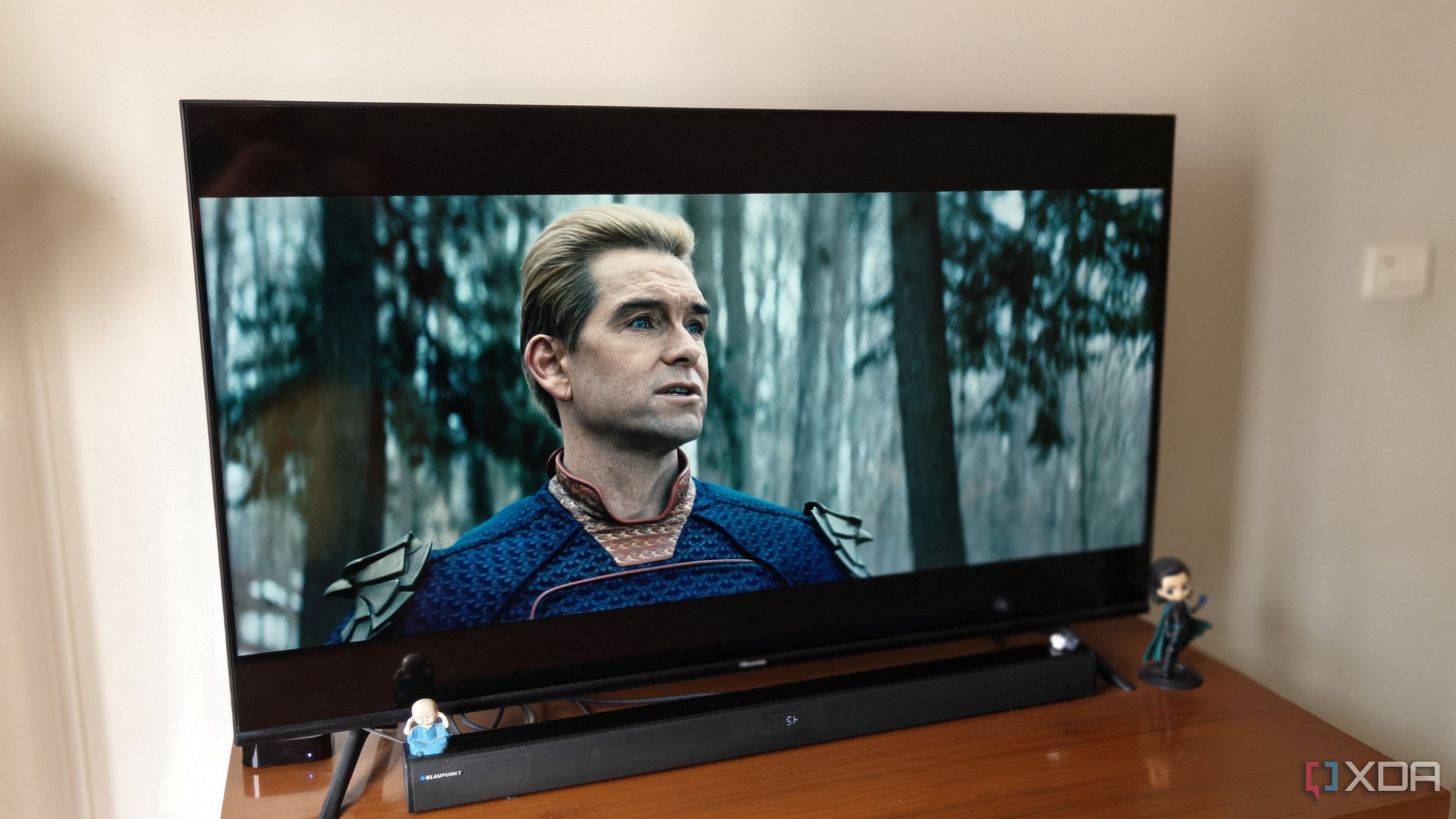 A smart TV on a brown table showing a scene from The Boys