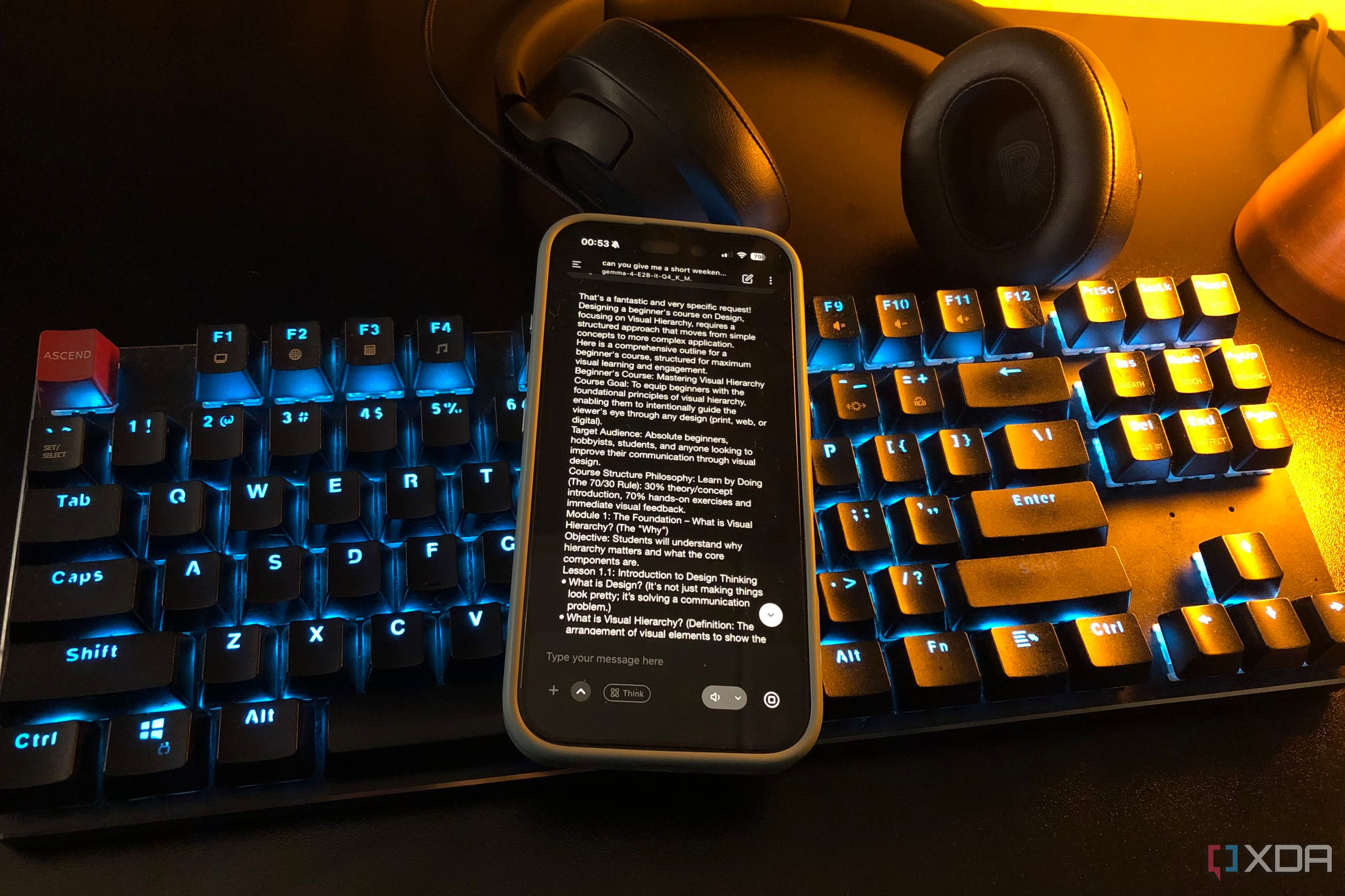 pocketpal on mobile phone on desktop keyboard, lamp and headset