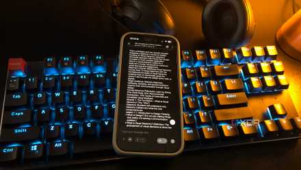 pocketpal on mobile phone on desktop keyboard, lamp and headset