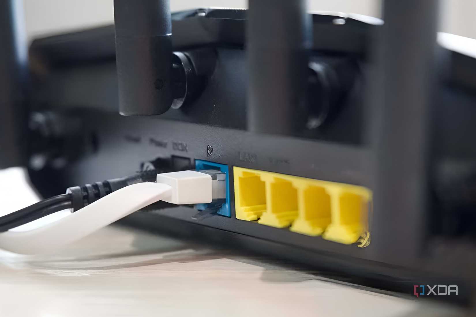 Rear view of Asus RT AX57 router showing arrangement of ports